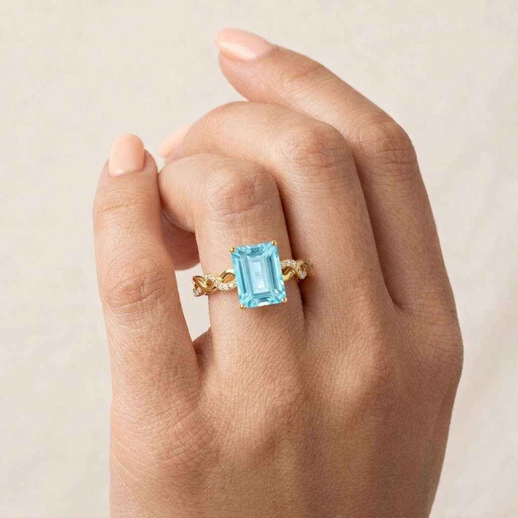 Emerald Cut Sky Blue Topaz & Moissanite Diamond Infinity Ring in 14 k Gold.
