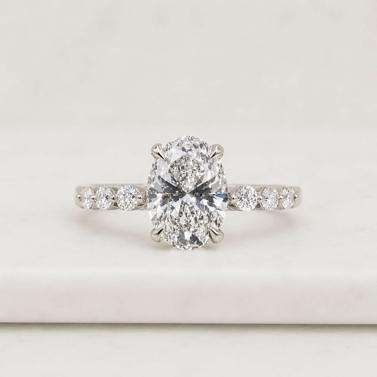oval cut lab grown diamond pavé engagement ring in 14k white gold