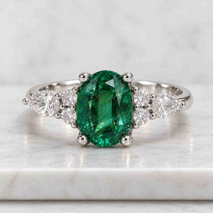 Oval Lab Grown Diamond Engagement Ring: 14K Gold Three Stone Emerald Accents
