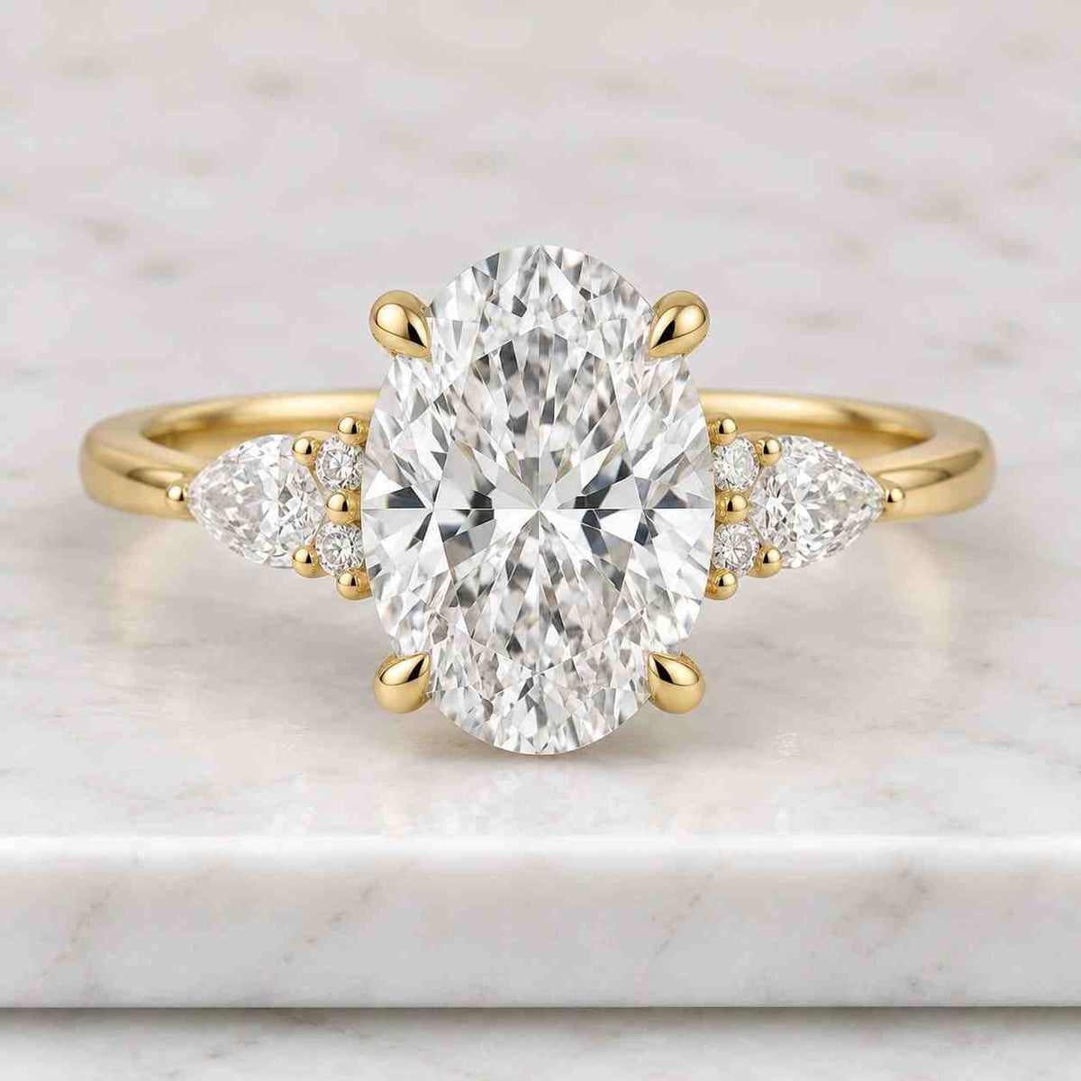 oval lab grown diamond three stone engagement ring, pear side stones, igi certified 14k yellow gold, d-f color vvs-vs1, handmade new york