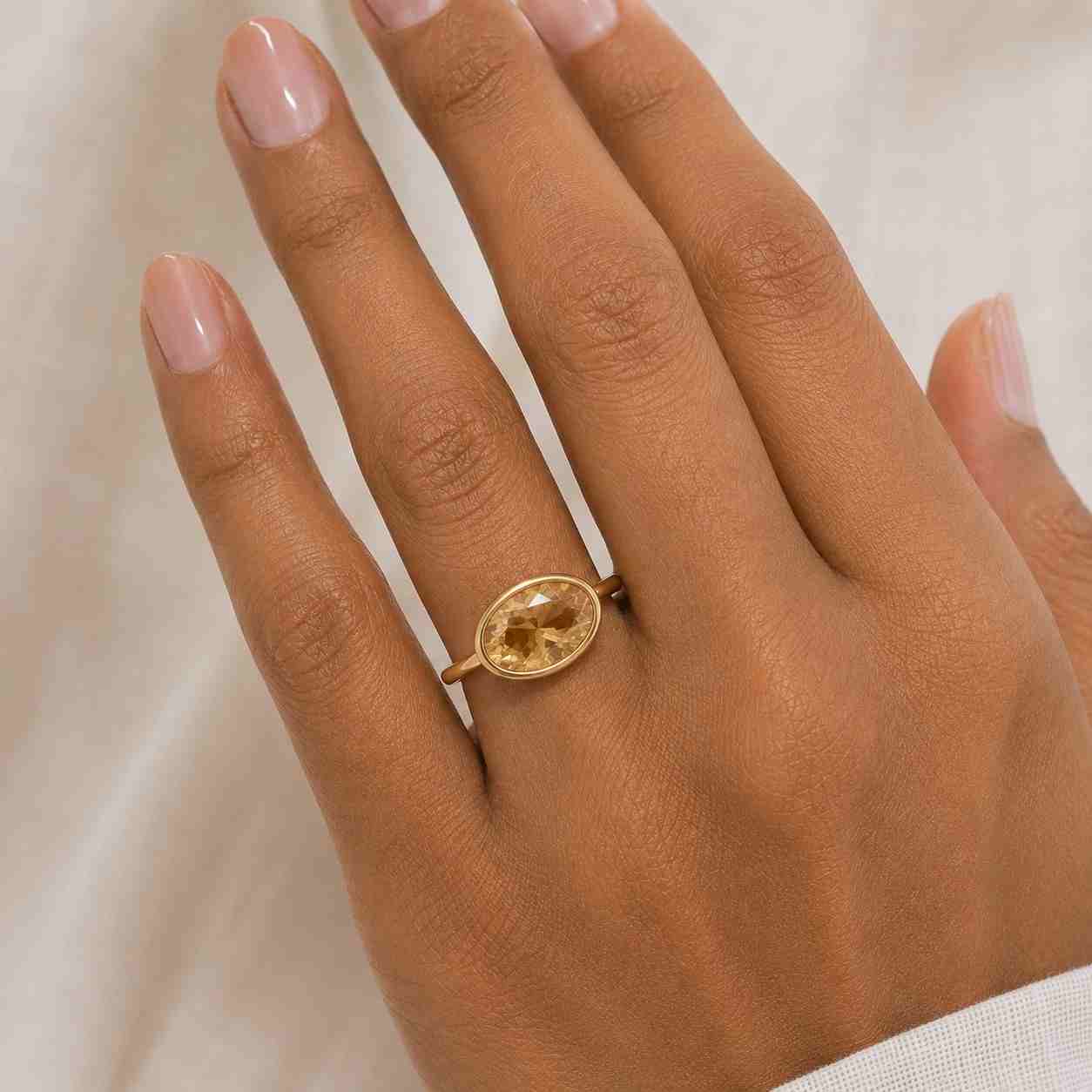 oval cut brown diamond ring with yellow gold bezel setting