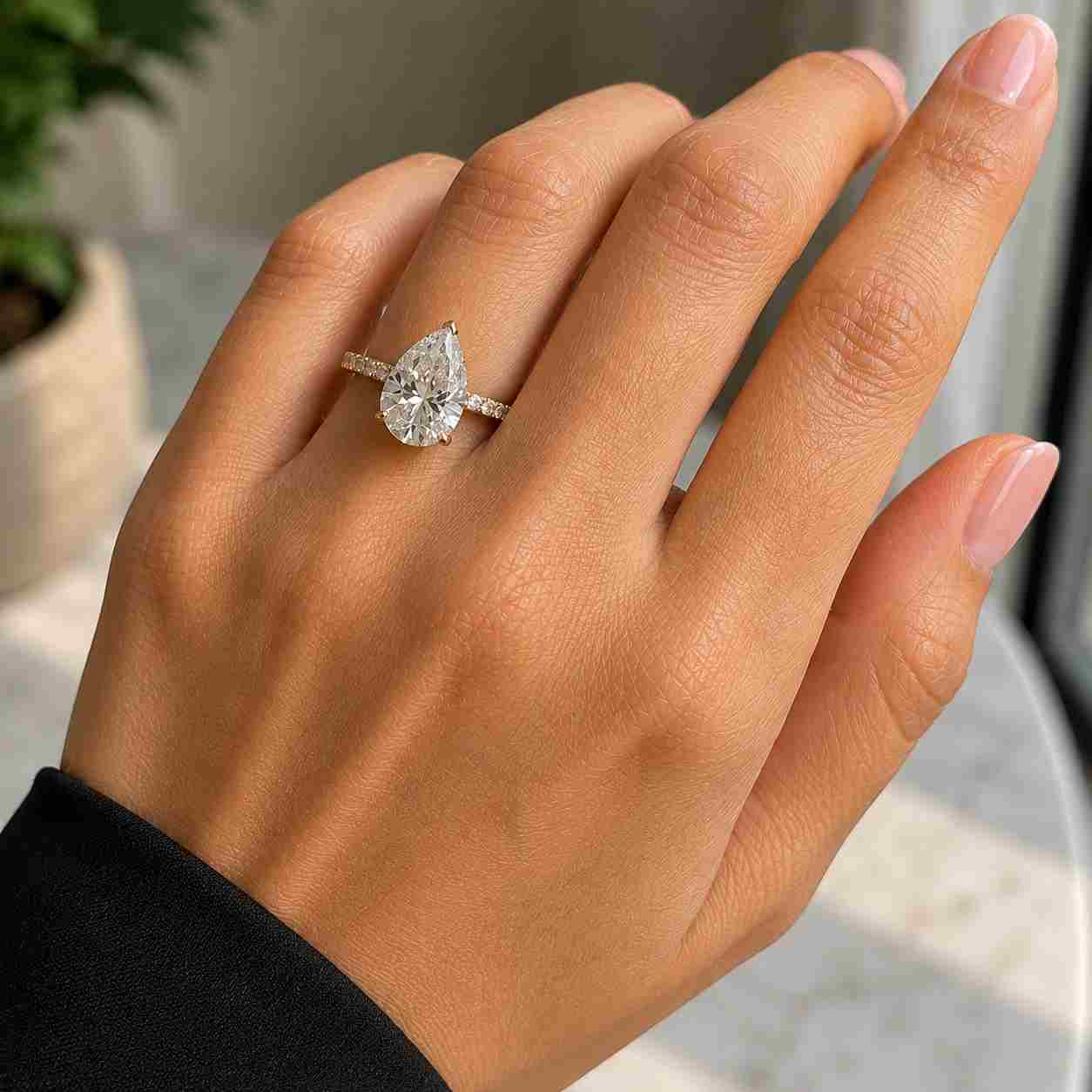 Pear cut moissanite diamond engagement ring with pave band