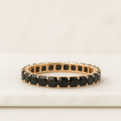 Gold ring with black gemstones