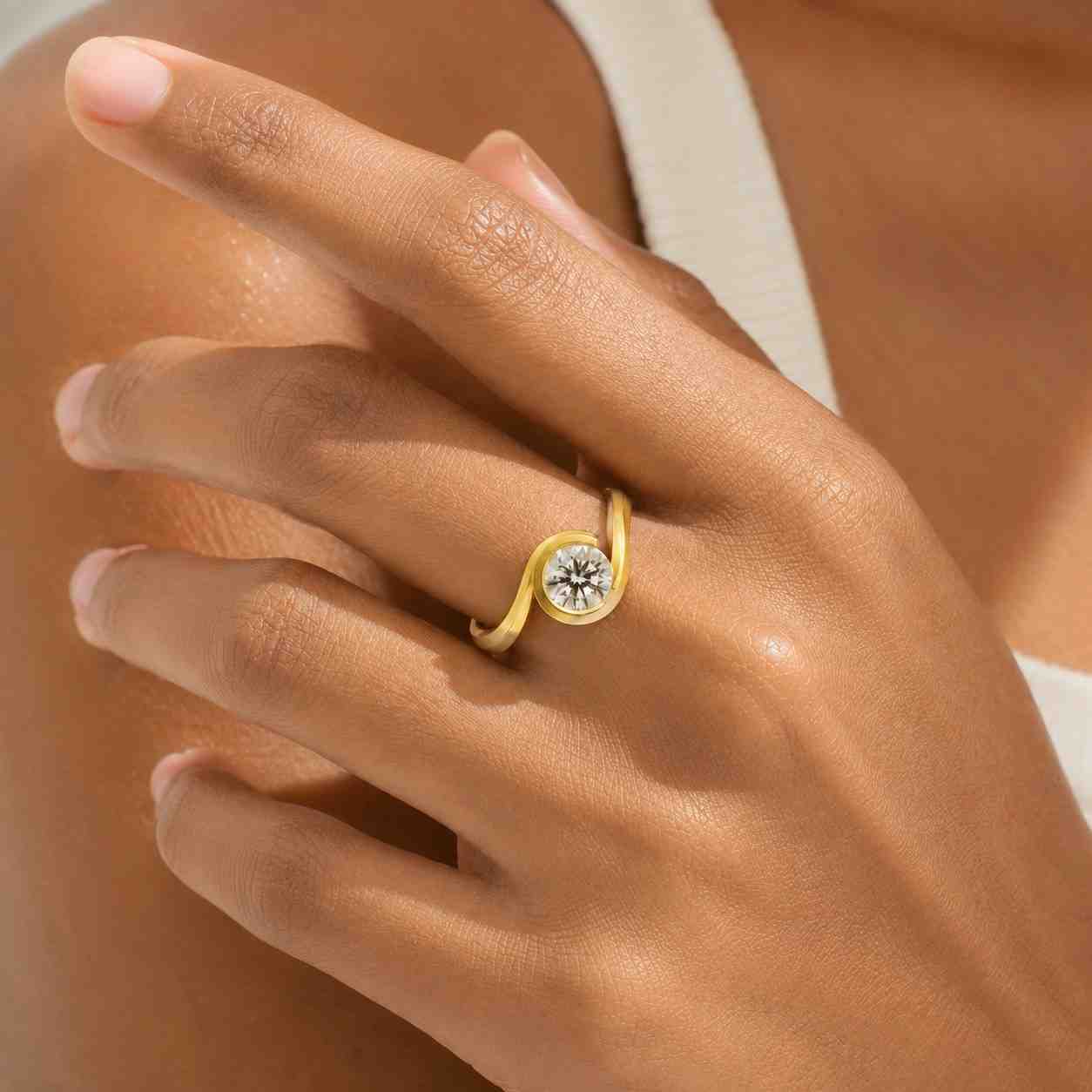 round cut lab grown diamond bypass ring: 18k yellow gold bezel engagement ring