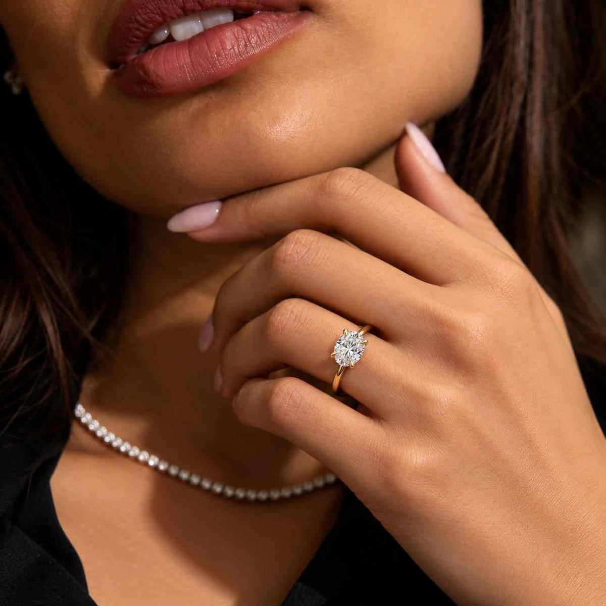 solid gold solitaire oval cut moissanite engagement ring east west set
