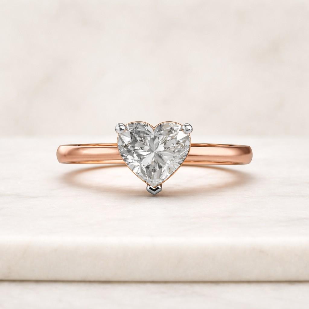 The heart-shaped center stone is secured with a classic three-prong setting that allows the diamond to remain the focal point while maintaining a light and balanced appearance.