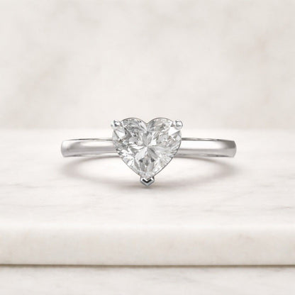 The solitaire setting highlights the shape and brilliance of the heart cut diamond while keeping the overall design minimal and easy to style.