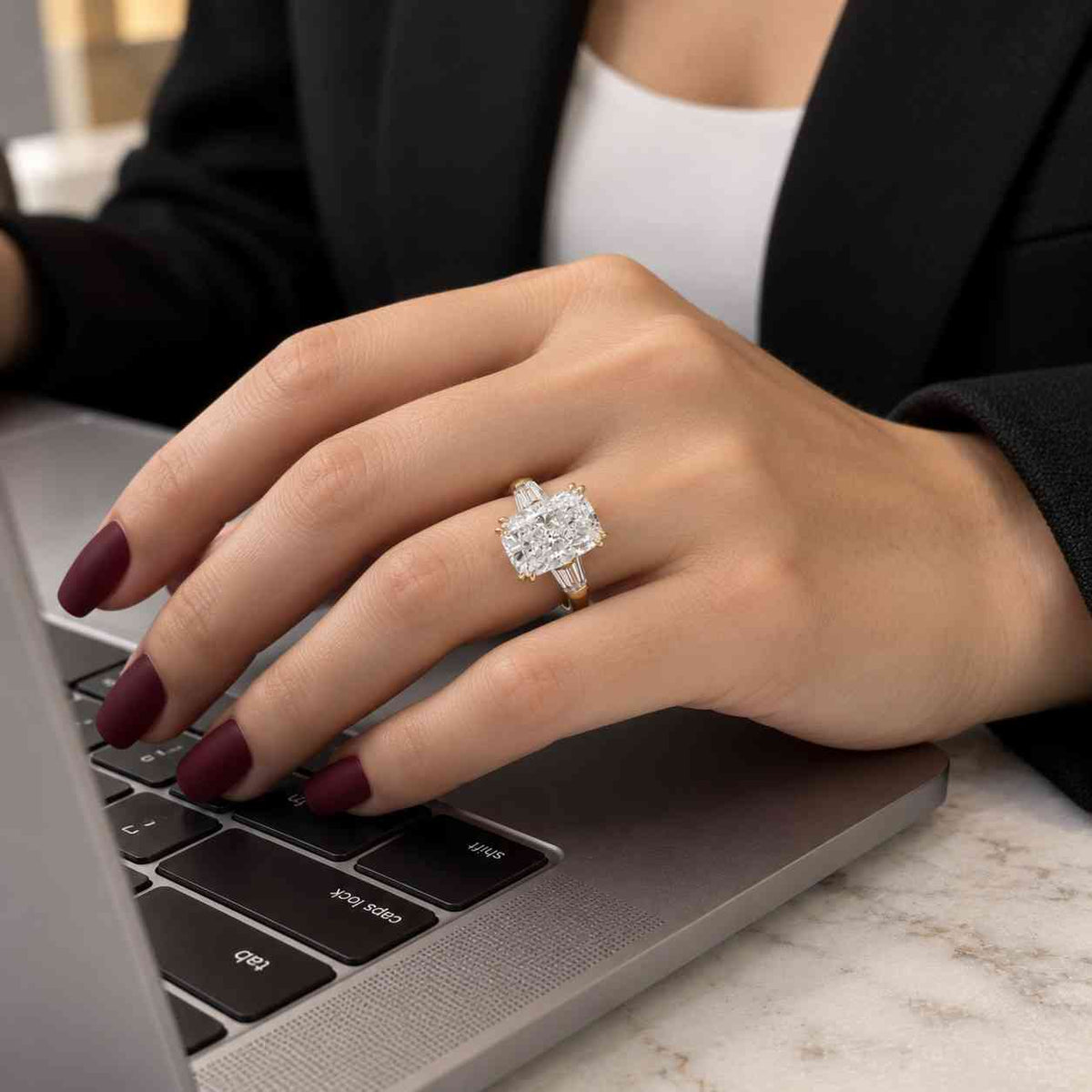 three stone cushion cut engagement ring with trapezoid side stones | igi certified
