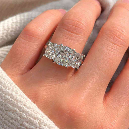 cushion engagement ring triple stone ring gold band ring luxury engagement ring bridal accessory ring clear gemstone ring statement jewelry ring handcrafted ring elegant jewelry ring fashion ring polished gold ring refined ring wedding band ring