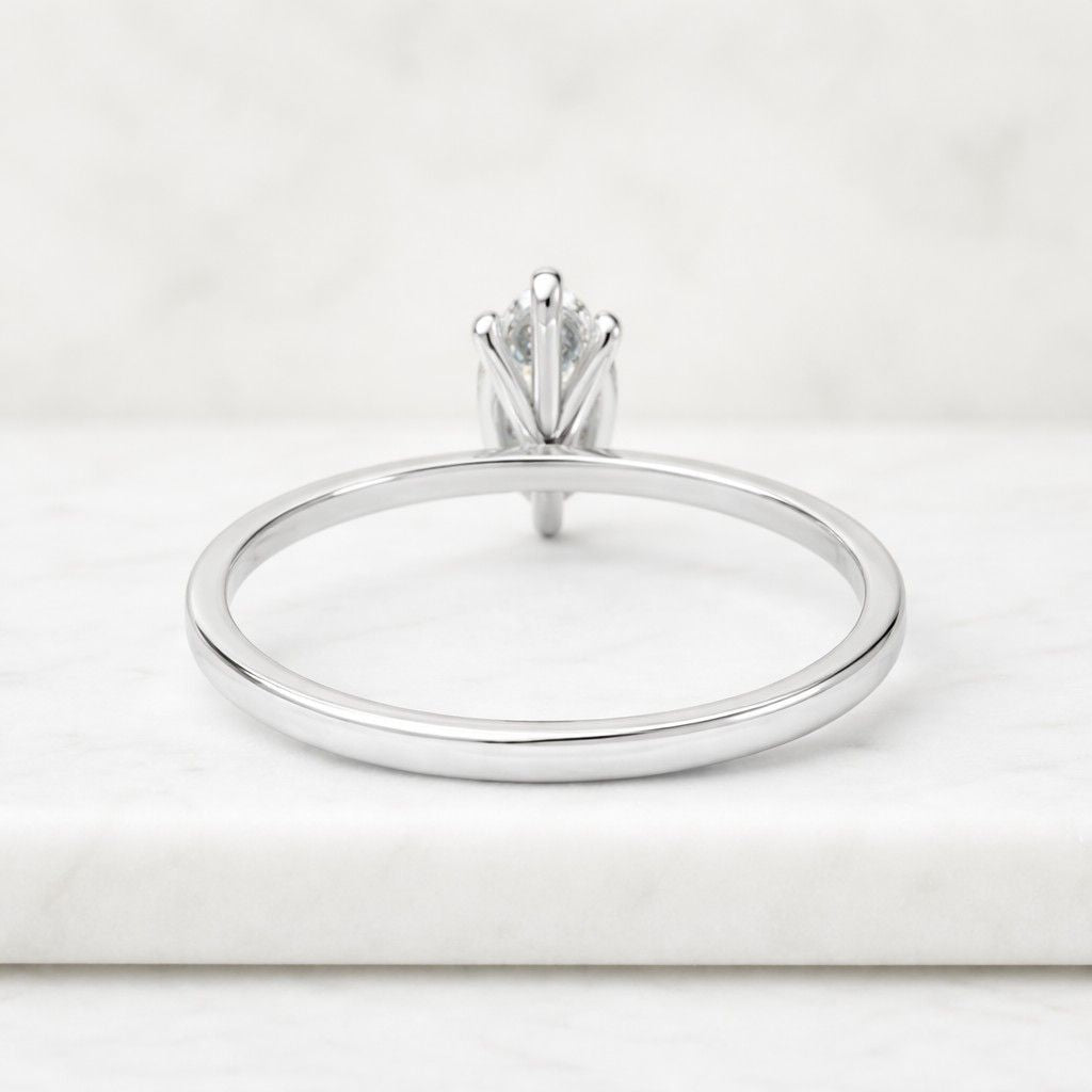 solid gold tulip set solitaire marquise cut moissanite engagement ring cathedral set
