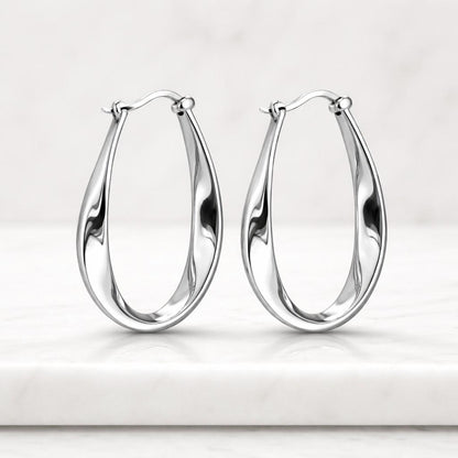refined earrings timeless hoops classy earrings upscale earrings oval jewelry sleek gold earrings high shine hoops chic gold hoops artistic earrings modern gold jewelry