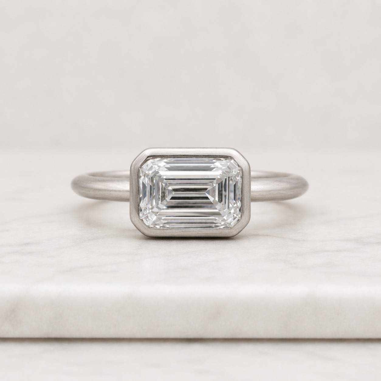 timeless ring chic ring gift ring unique ring rectangular stone ring bezel solitaire ring yellow metal ring bright stone ring clear gemstone ring refined ring delicate ring luxury jewelry simple ring modern jewelry ring